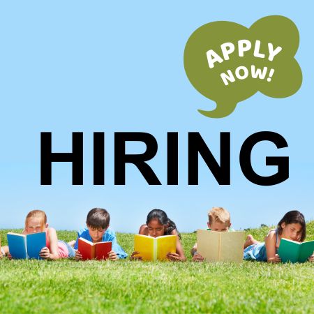 Five children lying on grass, reading colorful books, with "HIRING" in bold black letters and a green speech bubble saying "APPLY NOW!"