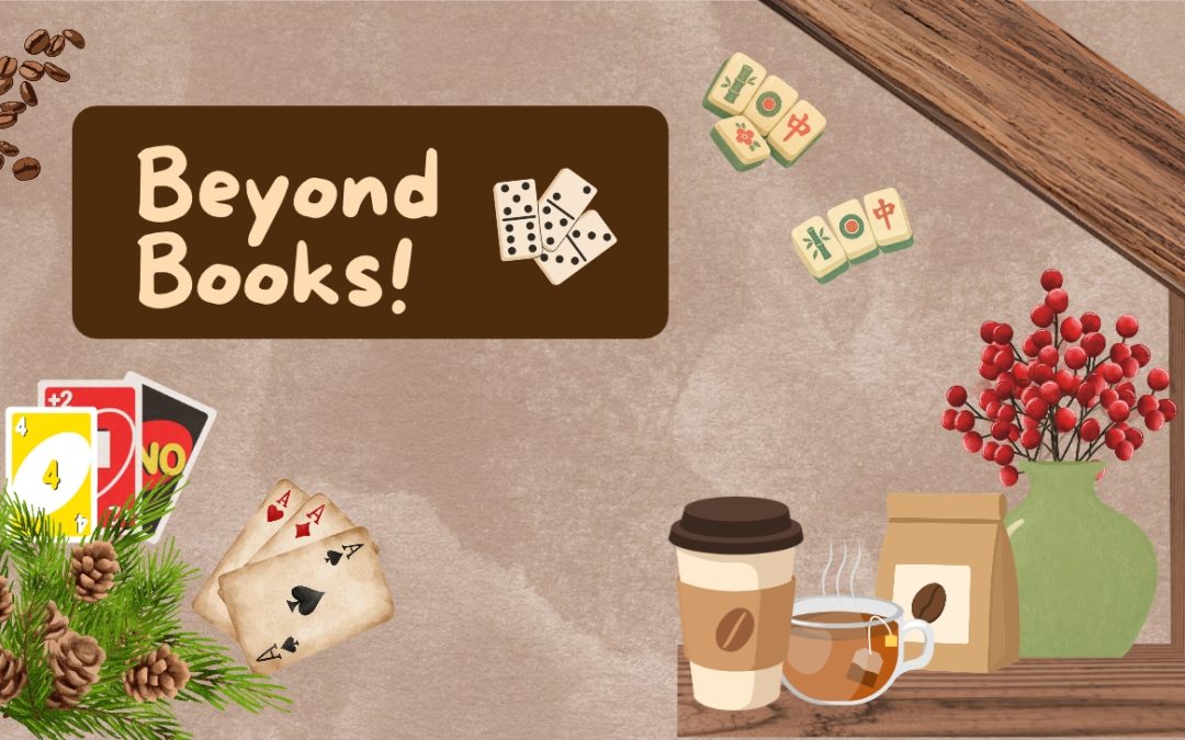 A cozy tabletop arrangement with books, coffee, game pieces, greenery, and a sign reading “Beyond Books!”
